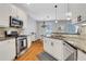 Modern open concept kitchen and dining area with stainless steel appliances at 620 Neel Reid Dr, Roswell, GA 30075