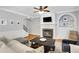 Cozy living room featuring a fireplace, built-in shelves, and hardwood floors at 620 Neel Reid Dr, Roswell, GA 30075