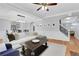Bright living room featuring a large sofa, hardwood floors, and open access to other rooms at 620 Neel Reid Dr, Roswell, GA 30075