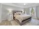 Serene main bedroom with tray ceiling, plush carpeting, and a luxurious upholstered bed at 620 Neel Reid Dr, Roswell, GA 30075