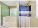 Bathroom view showcasing tub, shower, and window at 130 Stewart Hollow Ln, Covington, GA 30016