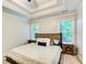Main bedroom with natural light, ceiling fan, tray ceiling, carpet floors, and stylish decor at 130 Stewart Hollow Ln, Covington, GA 30016