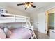 Well-lit bedroom with white bunk beds, soft grey walls, and a light brown carpet at 130 Stewart Hollow Ln, Covington, GA 30016