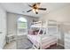 room with white bunk beds, an arched window, and a ceiling fan with integrated lighting at 130 Stewart Hollow Ln, Covington, GA 30016