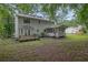 Spacious backyard view showcasing a screened in porch and deck of a two-story home at 2055 Pinella Dr, Grayson, GA 30017