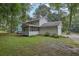 View of a two-story home with a large backyard and detached two-car garage at 2055 Pinella Dr, Grayson, GA 30017