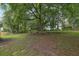 A tree filled backyard with greenery and shade in a residential area at 2055 Pinella Dr, Grayson, GA 30017