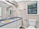 Bathroom features a double sink vanity, large mirror, and tub with shower at 2055 Pinella Dr, Grayson, GA 30017