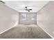 Spacious bedroom with neutral tones, two windows, and ceiling fan at 2055 Pinella Dr, Grayson, GA 30017