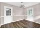 View of dining room features wood flooring and a decorative chandelier at 2055 Pinella Dr, Grayson, GA 30017