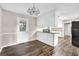 Dining Room features wood flooring, a decorative chandelier, and access to the kitchen at 2055 Pinella Dr, Grayson, GA 30017