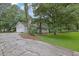 View of a two-story home with a cracked driveway, attached garage, and a spacious front lawn at 2055 Pinella Dr, Grayson, GA 30017