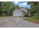 Spacious two-car garage with a cracked driveway leading up to a two-story home at 2055 Pinella Dr, Grayson, GA 30017