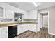 Well-lit kitchen with white cabinets, wood countertops, and modern appliances including a black dishwasher at 2055 Pinella Dr, Grayson, GA 30017