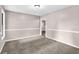 Neutral carpeted living room offers a versatile space with doorway to additional space at 2055 Pinella Dr, Grayson, GA 30017