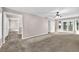 Spacious living room with a neutral colored carpet and walls, with adjacent spaces visible at 2055 Pinella Dr, Grayson, GA 30017