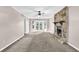 Bright living room with a stone fireplace, French doors, and neutral colored walls and carpet at 2055 Pinella Dr, Grayson, GA 30017