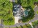An aerial view showcases a home with a luxurious pool and meticulously landscaped surroundings in a quiet neighborhood at 4304 Berkford Ne Cir, Brookhaven, GA 30319