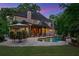 Backyard pool with patio, lush greenery, and an outdoor dining area at twilight at 4304 Berkford Ne Cir, Brookhaven, GA 30319