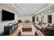 Spacious basement featuring leather seating, a bar area with stools, and a large television at 4304 Berkford Ne Cir, Brookhaven, GA 30319