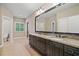 Bathroom with double vanities and dark cabinetry with granite countertops at 4304 Berkford Ne Cir, Brookhaven, GA 30319