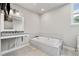Bathroom featuring a large soaking tub, vanity, and natural light at 4304 Berkford Ne Cir, Brookhaven, GA 30319