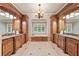 Elegant bathroom featuring dual vanities, a soaking tub, and custom wood cabinetry at 4304 Berkford Ne Cir, Brookhaven, GA 30319