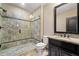 Bathroom featuring a tiled shower with a glass door, a vanity and a toilet at 4304 Berkford Ne Cir, Brookhaven, GA 30319