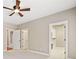 Neutral bedroom featuring a ceiling fan, carpeted floor, and doorway to the walk-in closet at 4304 Berkford Ne Cir, Brookhaven, GA 30319