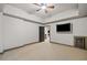 Spacious carpeted bedroom with tray ceiling, fan, and a wine cooler at 4304 Berkford Ne Cir, Brookhaven, GA 30319