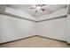 Empty carpeted bedroom with tray ceiling and ceiling fan, ready for personalization at 4304 Berkford Ne Cir, Brookhaven, GA 30319