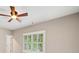 Bedroom features a ceiling fan and large window with plantation shutters at 4304 Berkford Ne Cir, Brookhaven, GA 30319