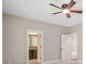 Bedroom with ceiling fan and doorway to ensuite bathroom and walk-in closet at 4304 Berkford Ne Cir, Brookhaven, GA 30319