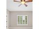 This bedroom features a ceiling fan and window with white shutters at 4304 Berkford Ne Cir, Brookhaven, GA 30319