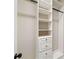 Walk-in closet with bright white built-in shelving and drawers at 4304 Berkford Ne Cir, Brookhaven, GA 30319