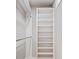 Walk-in closet with bright white built-in shelving and hanging bars at 4304 Berkford Ne Cir, Brookhaven, GA 30319