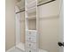 Walk-in closet with bright white built-in shelving and drawers at 4304 Berkford Ne Cir, Brookhaven, GA 30319