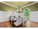 Formal dining room featuring hardwood floors, chandelier, wainscoting, and large windows at 4304 Berkford Ne Cir, Brookhaven, GA 30319