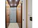 Interior view of an elevator featuring wood paneling and a folding gate at 4304 Berkford Ne Cir, Brookhaven, GA 30319