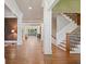 Grand foyer with hardwood floors, white columns, staircase, and views into other rooms at 4304 Berkford Ne Cir, Brookhaven, GA 30319