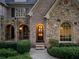 Inviting front entry with arched doorway, stone accents, and meticulous landscaping at 4304 Berkford Ne Cir, Brookhaven, GA 30319