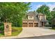 Brick home with a three-car garage and beautiful landscaping. Stone mailbox post with house number at 4304 Berkford Ne Cir, Brookhaven, GA 30319