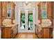 Hallway with elegant cabinetry and granite countertop, leading to a backyard oasis view, enhancing indoor-outdoor flow at 4304 Berkford Ne Cir, Brookhaven, GA 30319