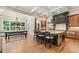 Open kitchen with a large island, hardwood floors, custom cabinetry, and stainless steel appliances at 4304 Berkford Ne Cir, Brookhaven, GA 30319