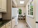 Functional laundry room with stacked washer and dryer, granite countertops, and ample storage space at 4304 Berkford Ne Cir, Brookhaven, GA 30319