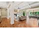 Bright living room with coffered ceilings, fireplace, built-ins, hardwood floors and many windows at 4304 Berkford Ne Cir, Brookhaven, GA 30319
