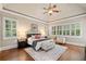 Spacious main bedroom with hardwood floors, tray ceilings, plantation shutters, and a ceiling fan at 4304 Berkford Ne Cir, Brookhaven, GA 30319