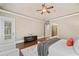 Serene main bedroom showcasing hardwood floors, tray ceilings, and a walk-out to the balcony at 4304 Berkford Ne Cir, Brookhaven, GA 30319