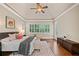 Bright main bedroom featuring hardwood floors, plantation shutters, and a comfortable seating area at 4304 Berkford Ne Cir, Brookhaven, GA 30319