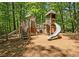 Charming wooden playground with slides, stairs and towers set amidst a lush, green forest at 4304 Berkford Ne Cir, Brookhaven, GA 30319